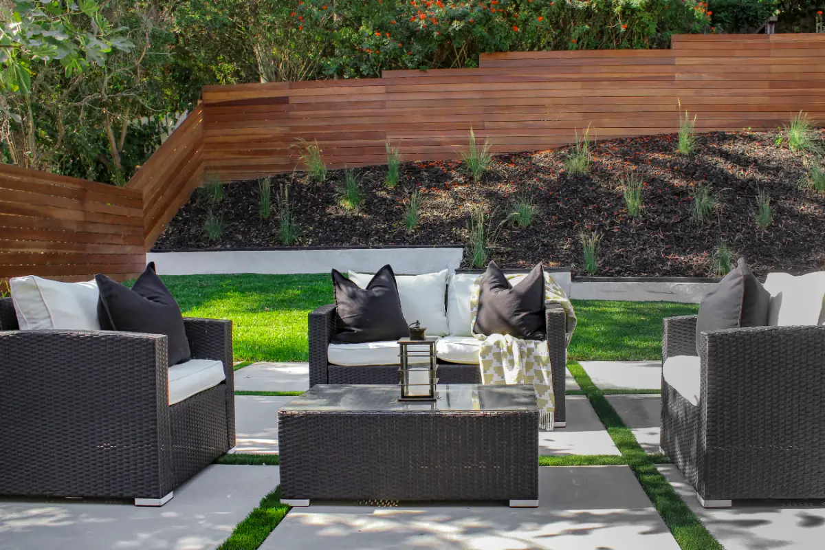 Backyard lounge with paver patio, turf strips and ipe retaining walls