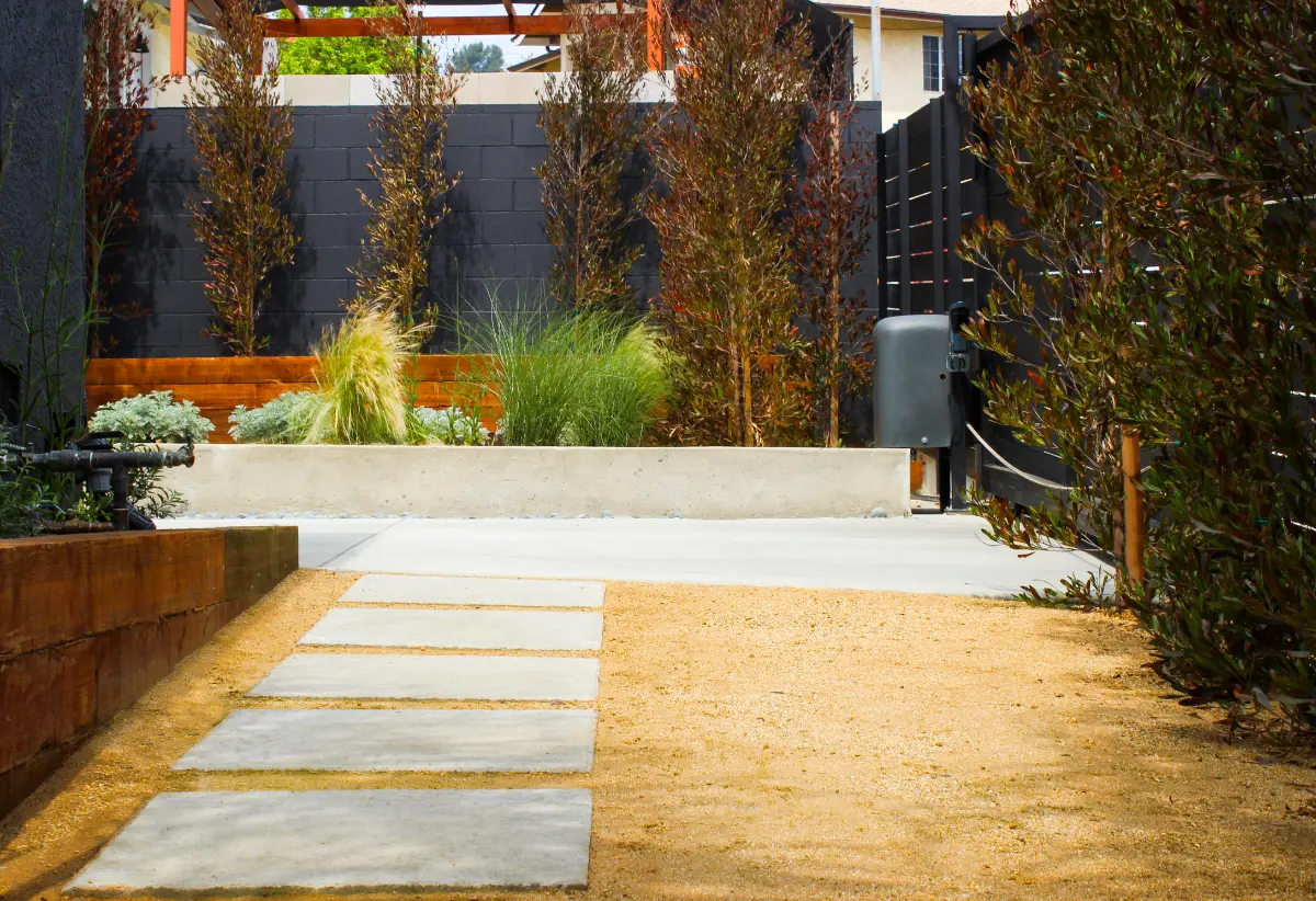 Side yard with concrete pavers, decomposed granite and planter wall