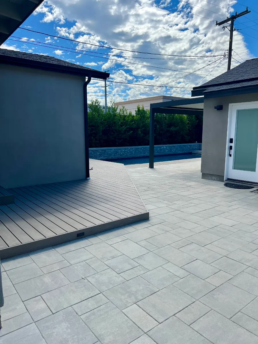Backyard pool with large-format pavers, composite deck and pergola